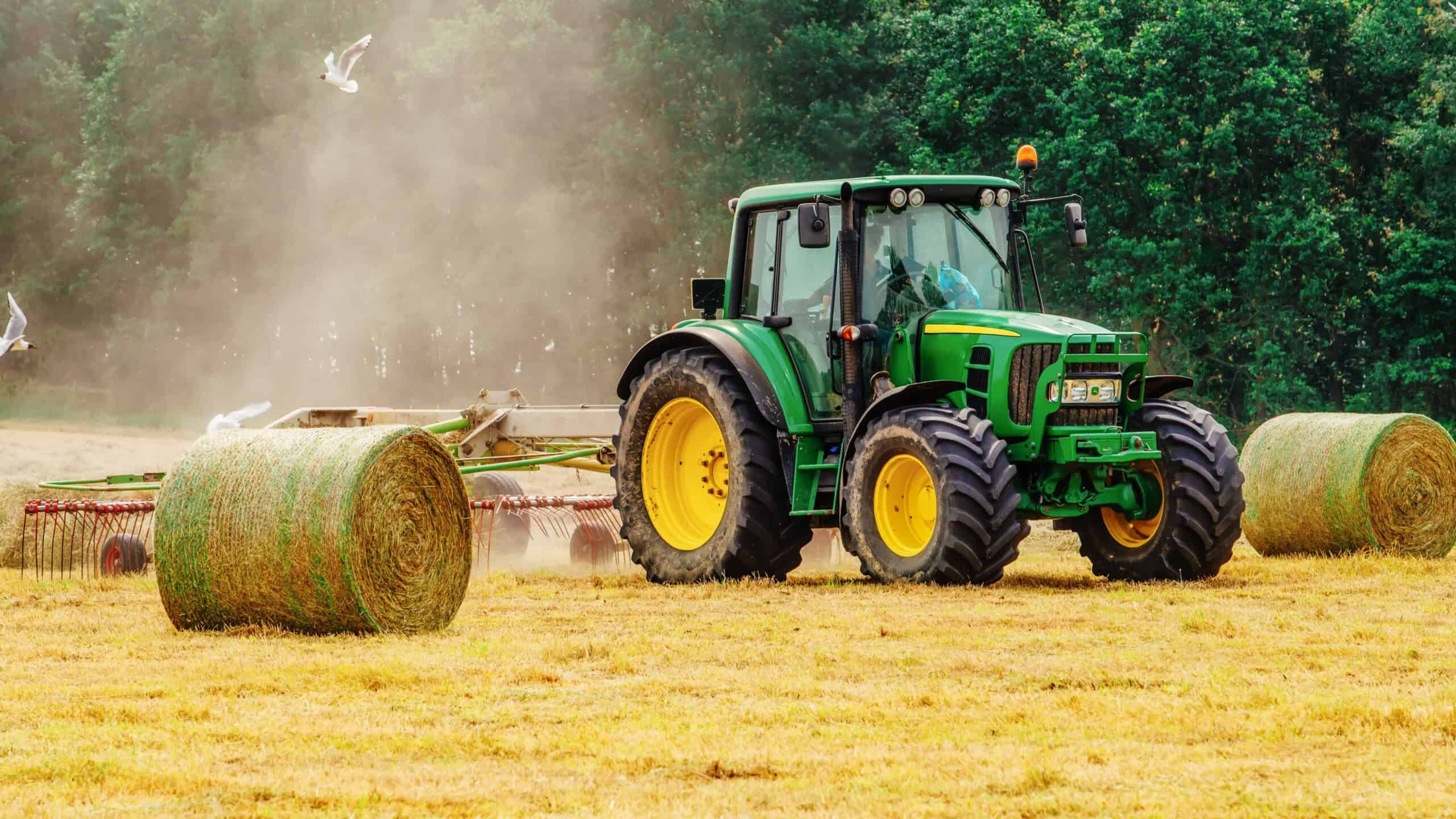 Tractor harvesting hay, ensuring a plentiful harvest